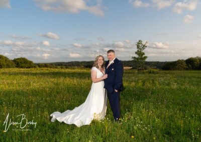 Rackleys wedding photography. Bride and groom in wild flower meadow at Rackleys in August.