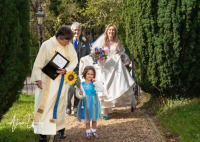 Small wedding in Buckinghamshire. Bride arriving at church in Seer Green.