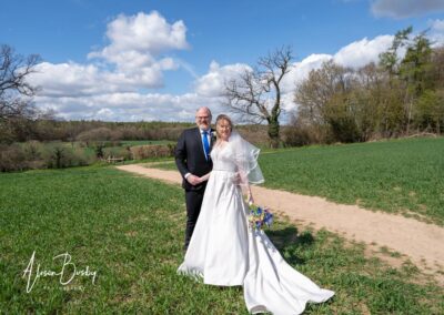 Small wedding in Buckinghamshire. Bride and groom on farmland near Seer Green.