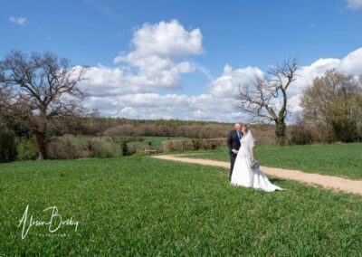 Small wedding in Buckinghamshire. Bride and groom kiss in Buckinghamshire countryside.