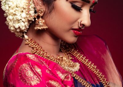 Wedding hairstyles. India bridal hair with white jasmine and jewelled decorations