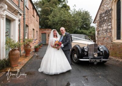 Wedding photography for older couples. Bride and groom next to bentley.