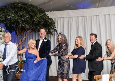 Wedding photography for older couples. Conga line with bride in blue wedding dress.