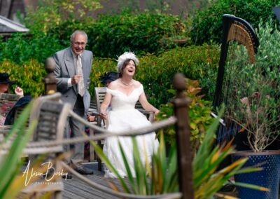 Wedding photography for older couples. Bride laughing with guests.