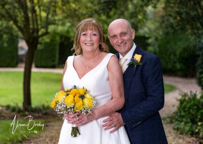 Wedding photography for older couples. Bride and groom portrait in garden