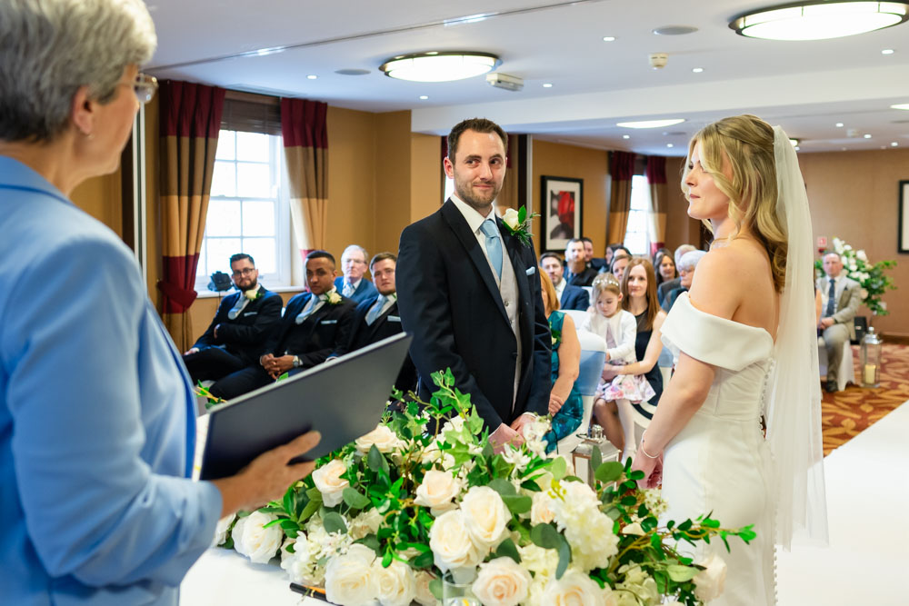 Bride and groom during wedding ceremony at the Bull Hotel in Gerrards Cross