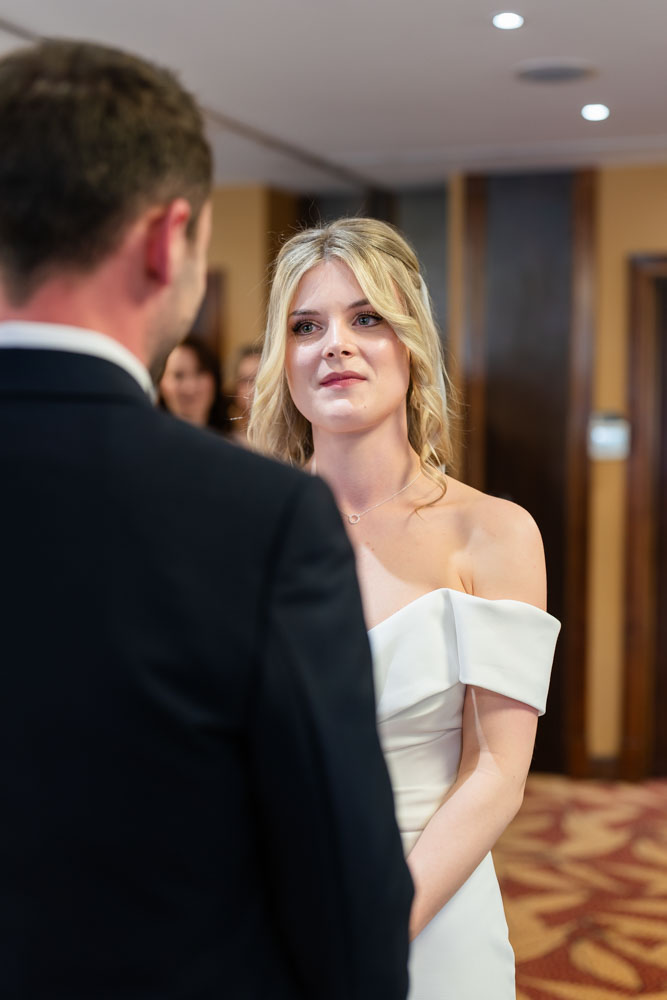 Bride and groom during wedding ceremony at the Bull Hotel in Gerrards Cross