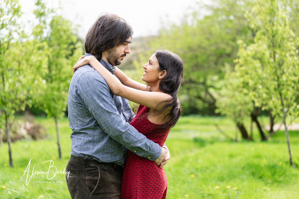 Amersham engagement photos. Young couple embrace in Buckinghamshire garden.