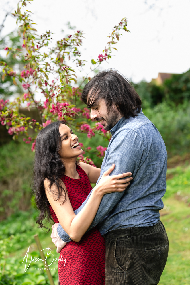 Amersham engagement photos. Young couple laughing in Buckinghamshire garden