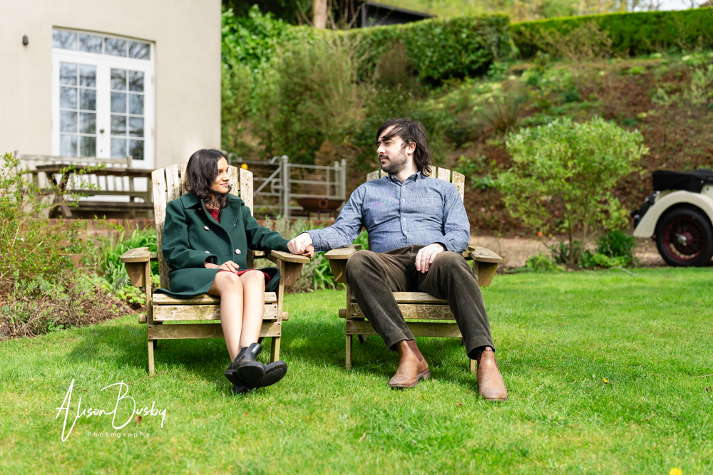 Amersham engagement photos. Young couple seated in Buckinghamshire garden