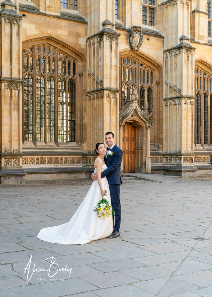 Bride and groom embrace near the Wren door of the Bodleian Library in Oxford. By Bodleian Library wedding photographer.