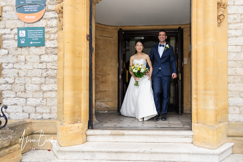 Bride and groom leaving Tidmarsh Lane registry office by Oxford photographer Alison Busby.