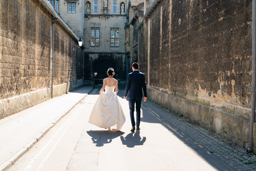 Bride and groom Walking to New College Oxford