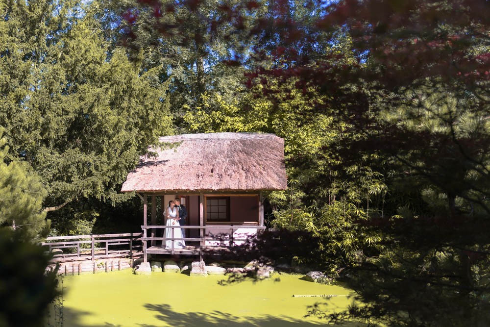 Oxfordshire wedding Le Manoir aux Quat’Saisons. Bride and groom kiss in the Japanese Tea garden