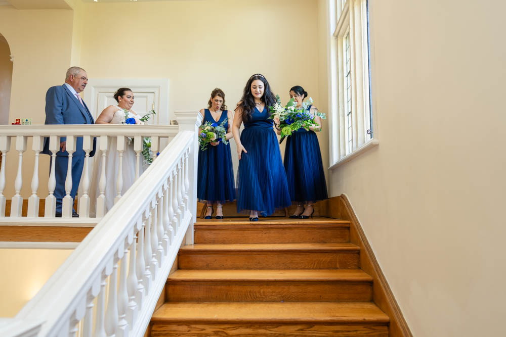 Notley Abbey wedding photographer. Bride and bridesmaids on staircase