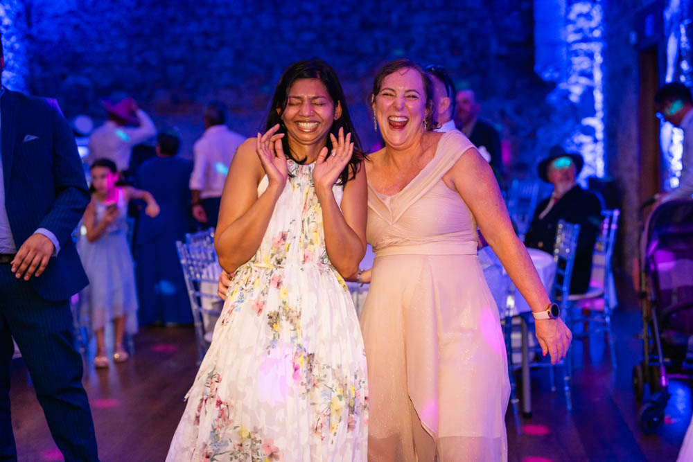 Notley Abbey wedding photographer. Guests laughing in the Monks refectory.