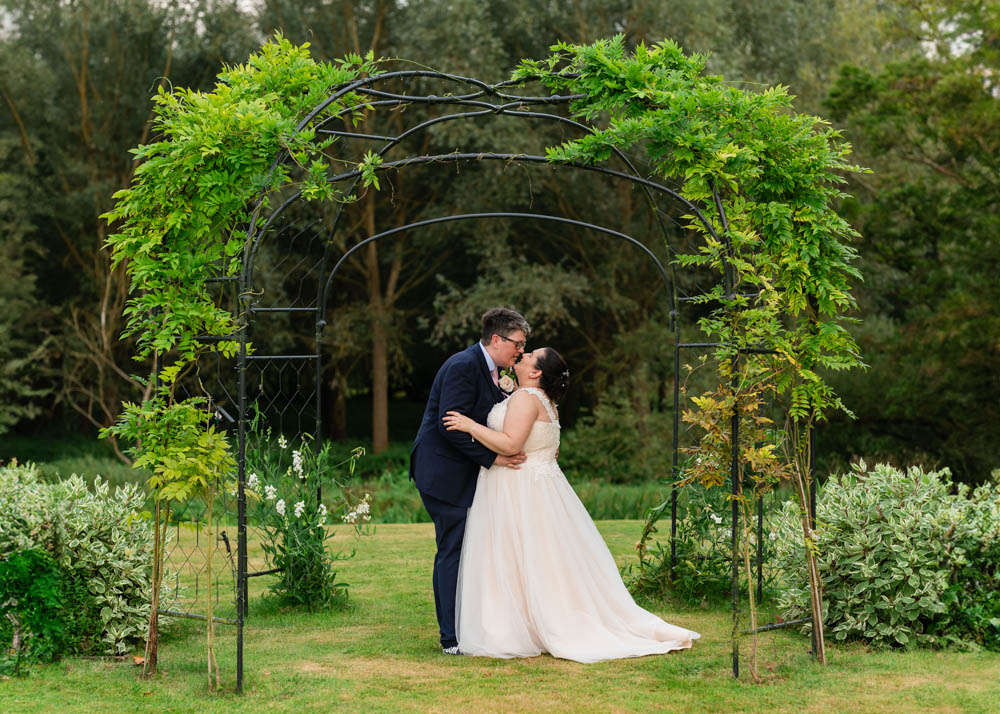 Notley Abbey wedding photographer. Bride and groom portrait next to the River Thame.