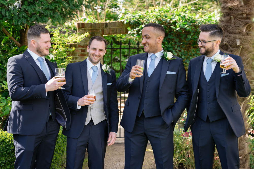 Groomsmen laughing at Bull Hotel wedding