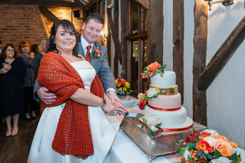 Cantley House wedding photographer. Bride and groom cutting cake