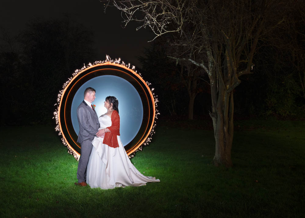 Cantley House wedding photographer. Bride and groom with light painting in gardens at night.