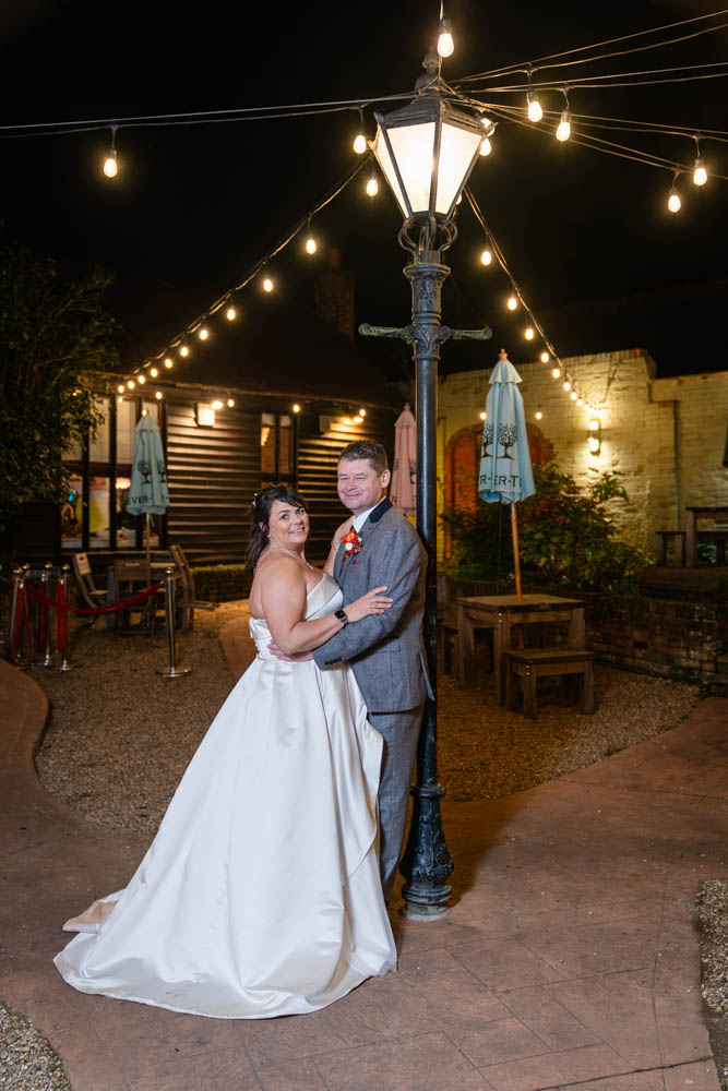Cantley House wedding photographer. Bride and groom next to street lamp at night