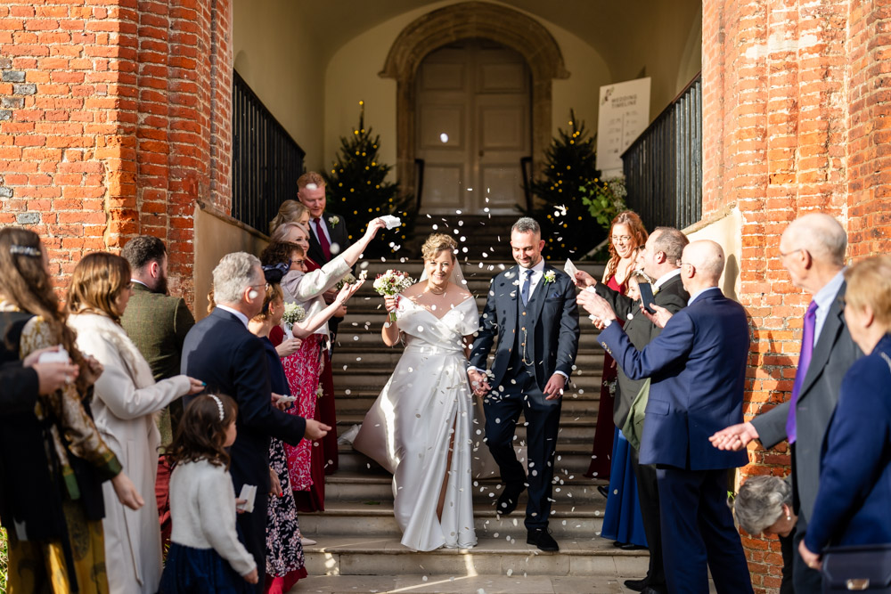 Farnham castle wedding photographer. Bride and groom in confetti tunnel at Foxes Steps.