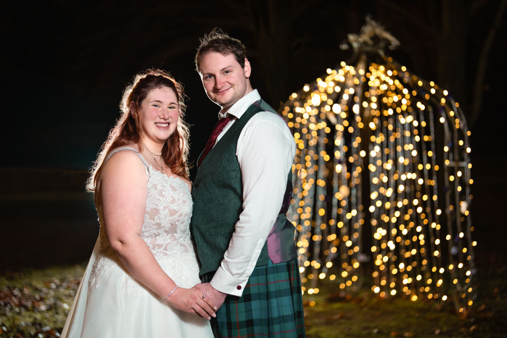 Night photo of bride and groom with arbor fairy lights at the Garden House Venue in Steventon, Oxfordshire