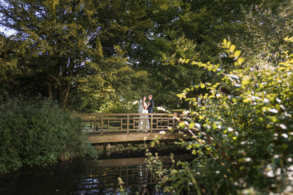 Oxfordshire wedding Le Manoir aux Quat’Saisons. Bride and groom on the bridge in the Japanese Tea Garden.