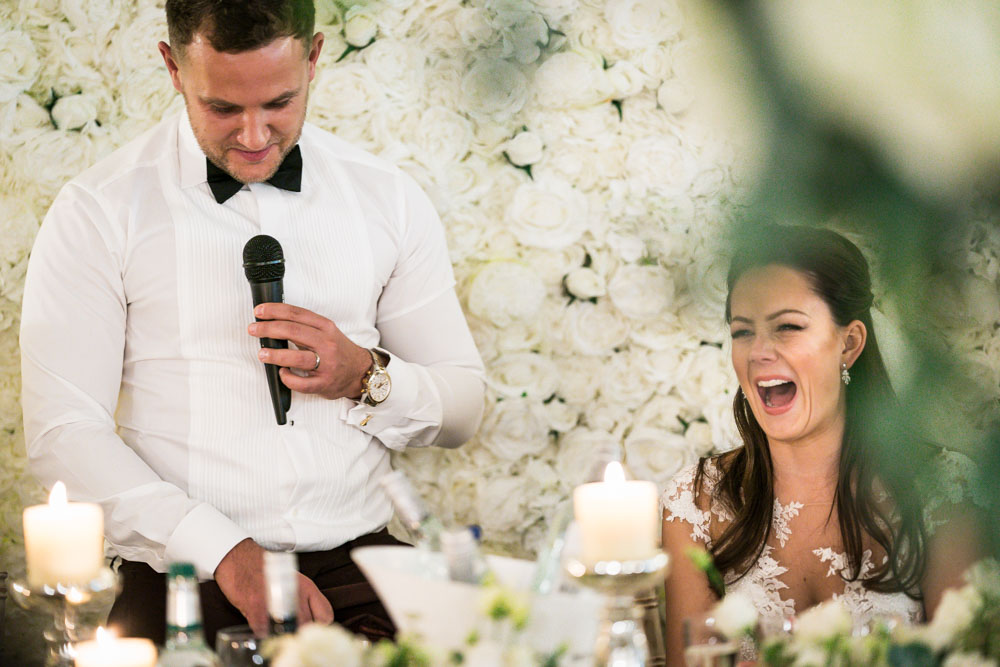 Wedding photography buckinghamshire. bride and groom laughing during speeches