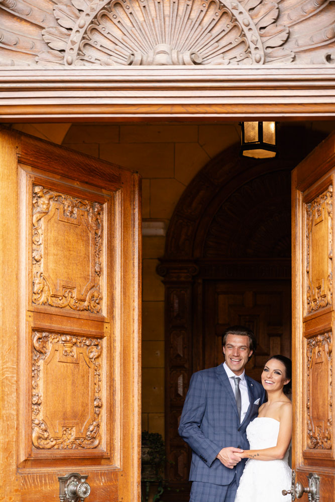 Wedding photography Oxfordshire. Bride and groom at entrance to Eynsham Hall