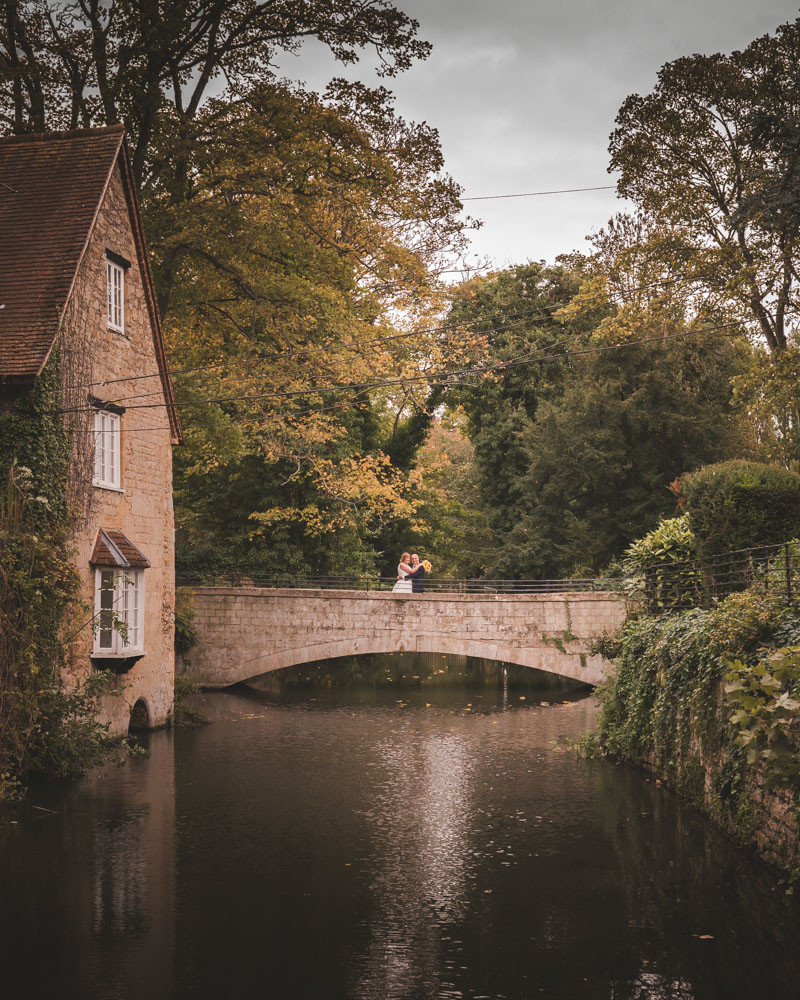 Wedding photos Coseners House. Bride and groom on bridge at autumn wedding.
