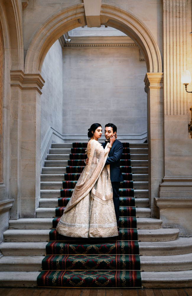 Wedding photos Heythrop Park. Bride and groom on steps inside georgian house