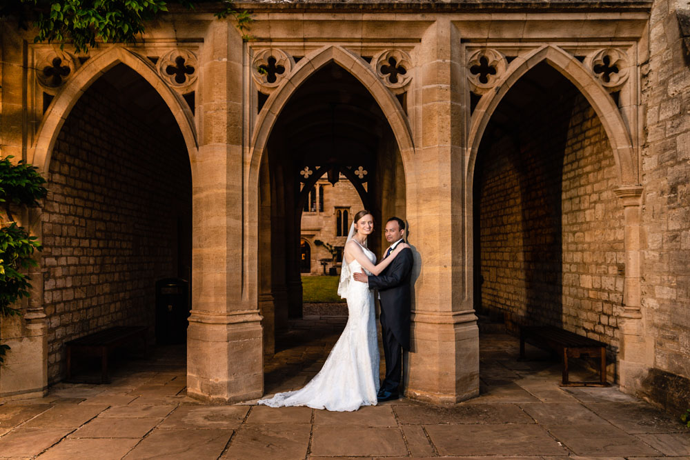 Bride and groom at four colleges arches at St Cross College Oxford