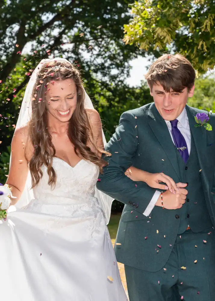 Bride and groom in confetti tunnel by Buckinghamshire wedding photographer Alison B