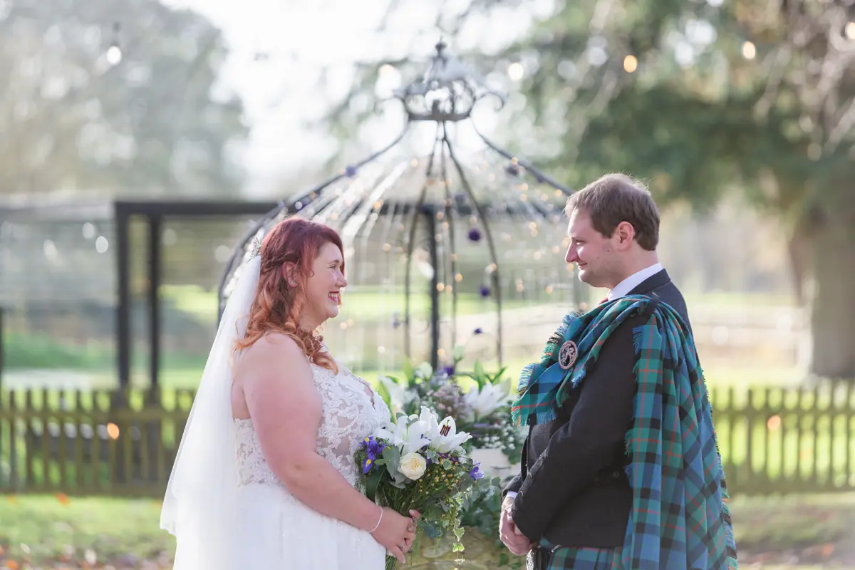 Bride and groom exchange vows at their Garden house venue wedding.