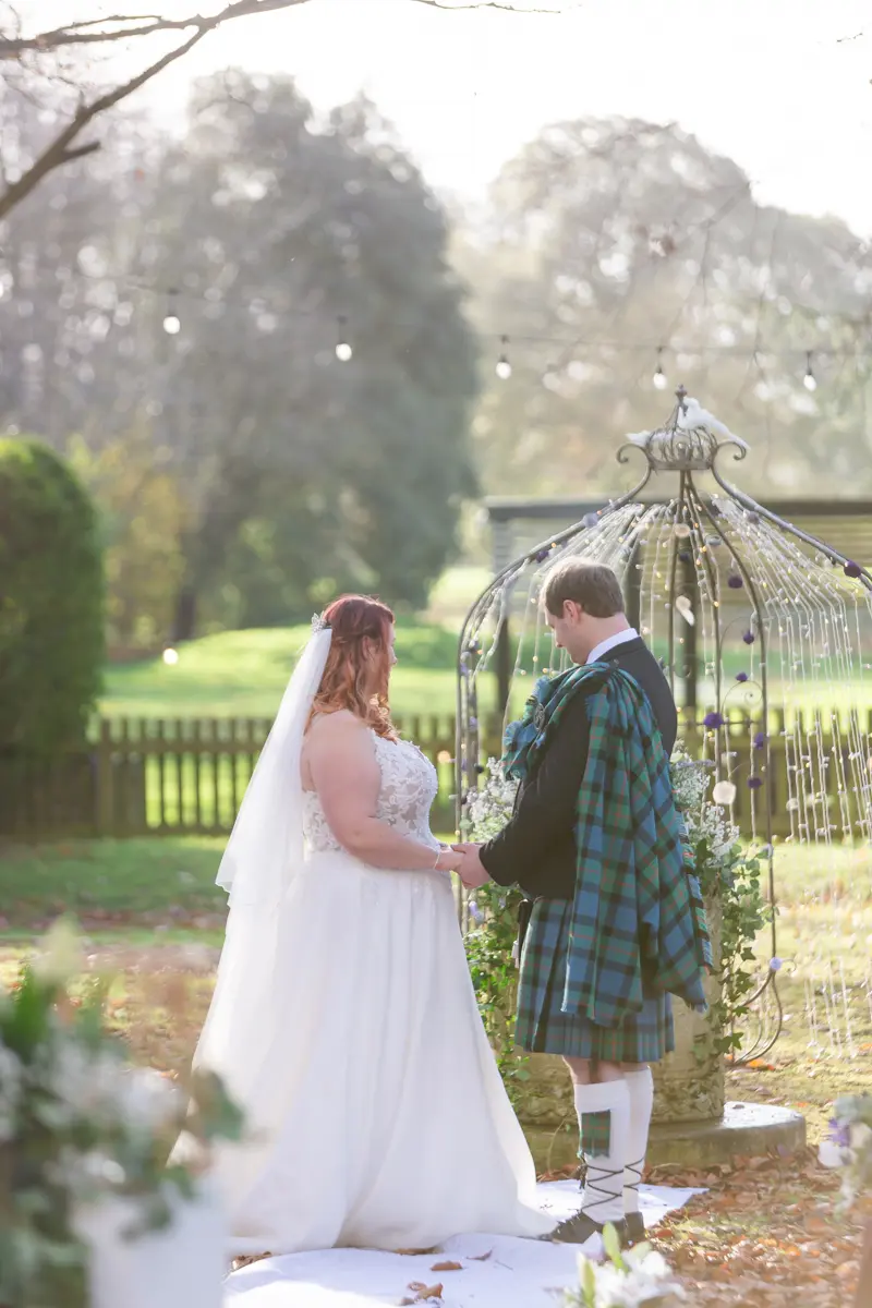 Bride and groom exchange vows at their Garden house venue wedding.