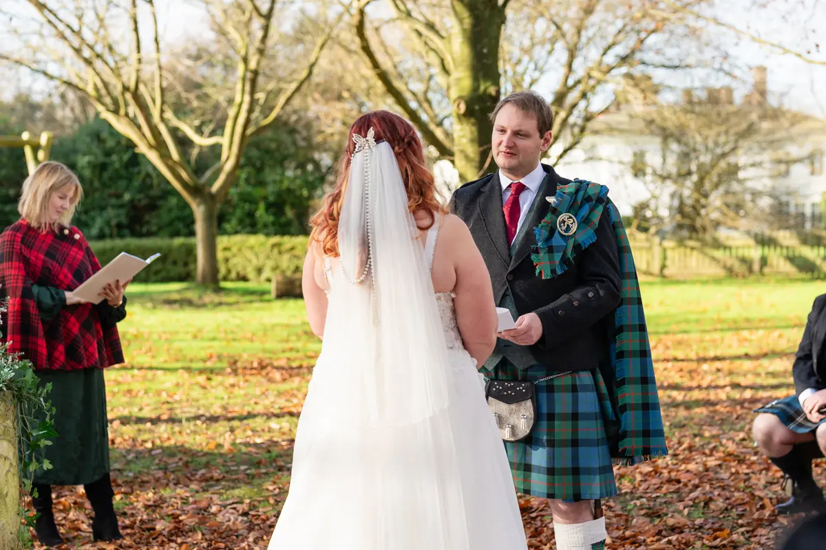 Bride and groom exchange vows at their Garden house venue wedding.