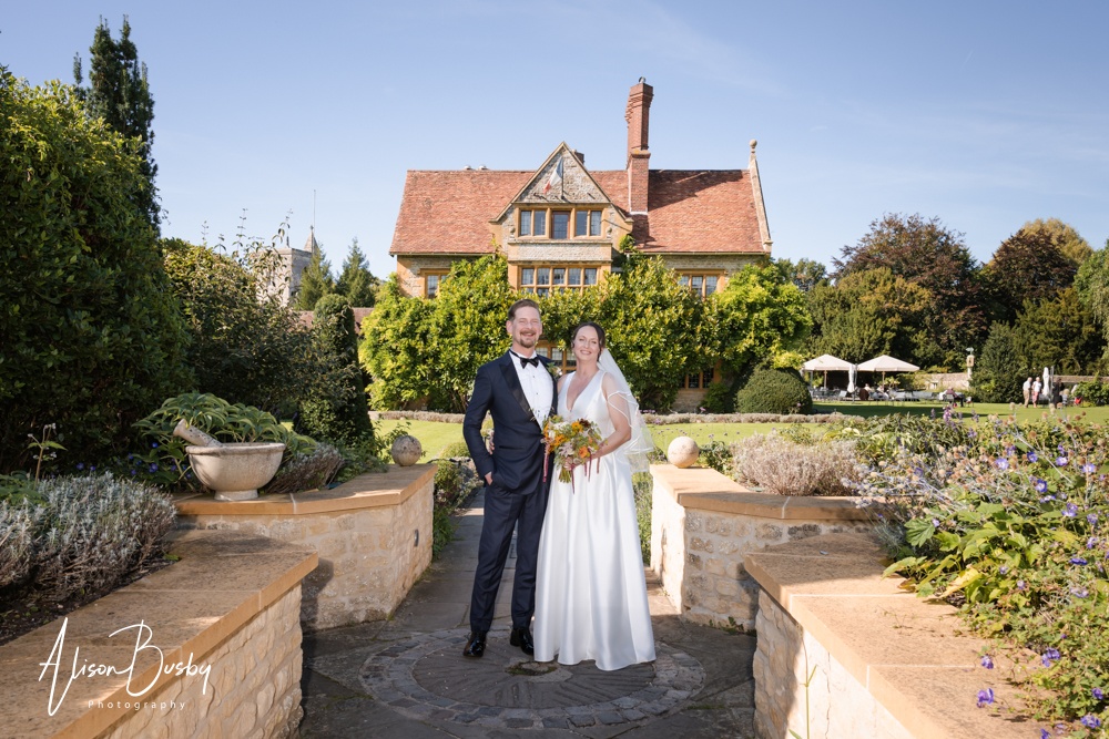 Le Manoir wedding photographer with bride and groom on lavender path leading to the hotel