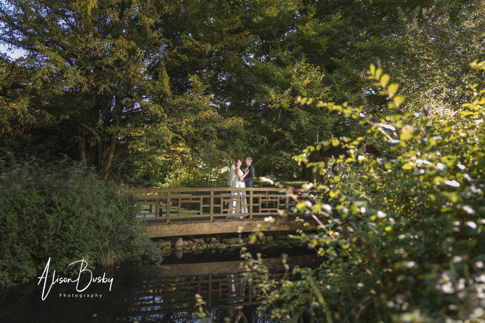 Le Manoir wedding photographer with Bride and groom on bridge in Japanese Tea garden of Le Manoir aux Quat'Saisons.