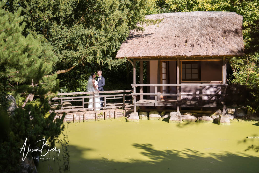 Bride and groom next to lodge in Japanese Tea Garden at Le Manoir aux Quat'Saisons wedding photographer.