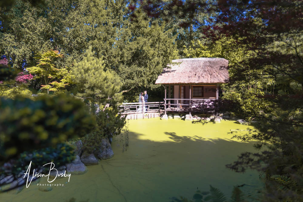 Bride and groom next to lodge in Japanese Tea Garden at Le Manoir aux Quat'Saisons wedding photographer.