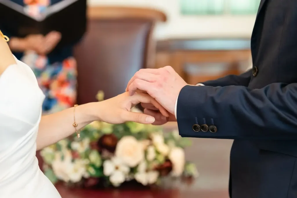 Wedding in Oxford. Bride and groom exchange rings during wedding ceremony at Oxford registry office in Tidmarsh Lane.