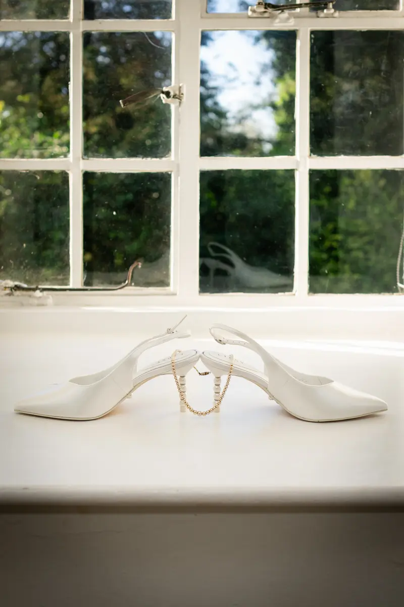Wedding shoes on window sill at Farnham Castle wedding.