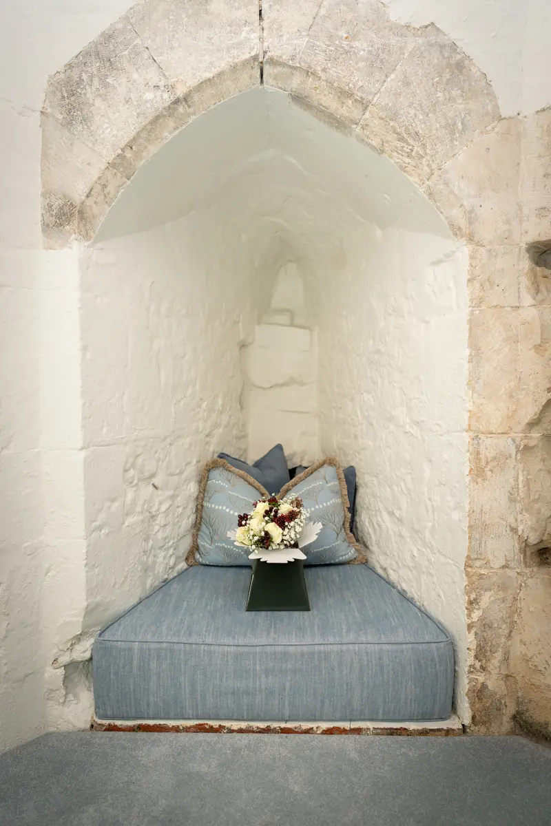 Bridal bouquet in alcove at Farnham Castle wedding.