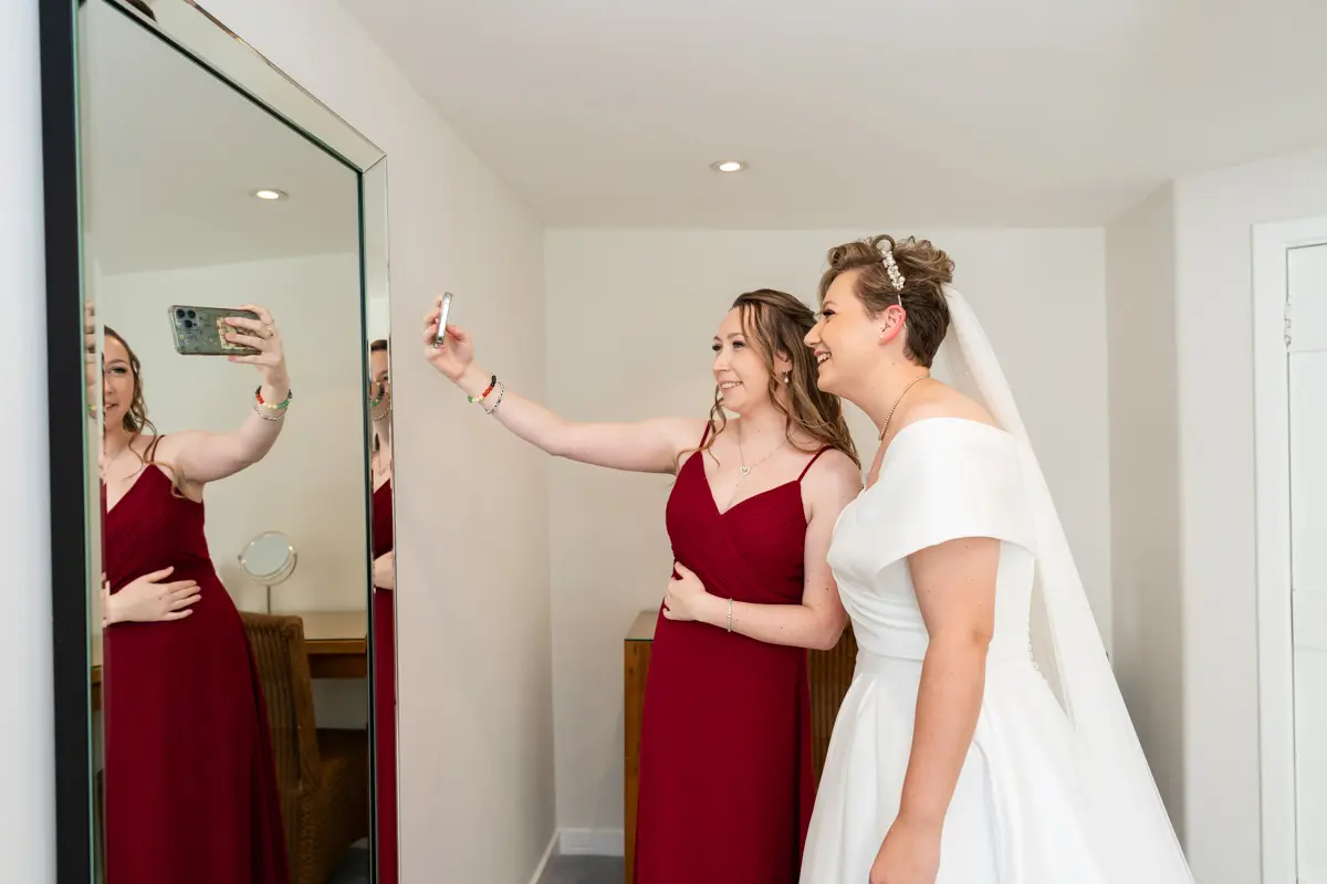 Bride and bridesmaid selfie at Farnham Castle wedding.
