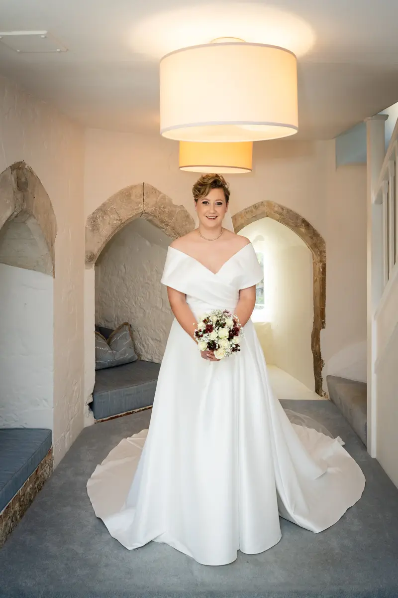 Bride in gatehouse at Farnham Castle wedding.