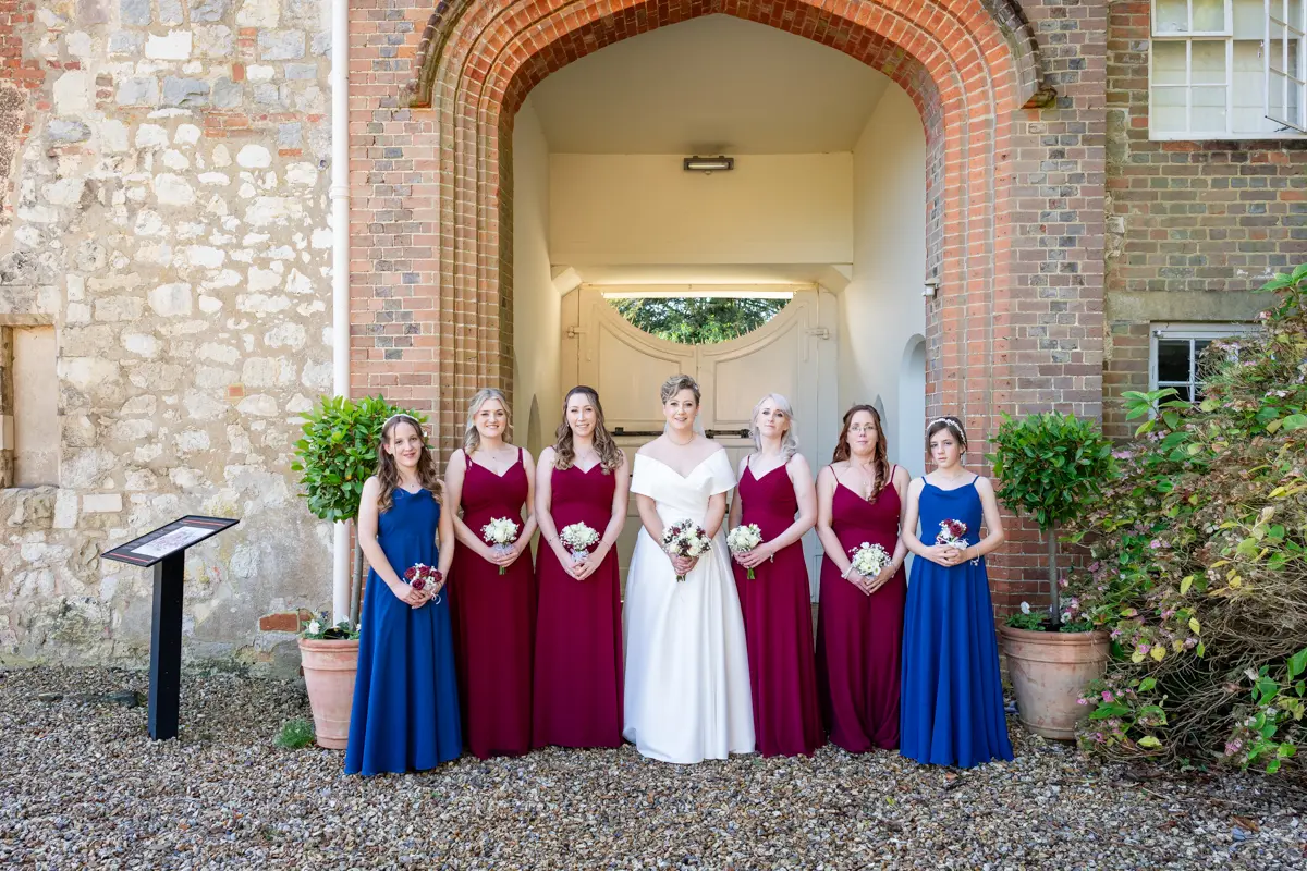 Bridal party in front of gatehouse at Farnham Castle wedding.