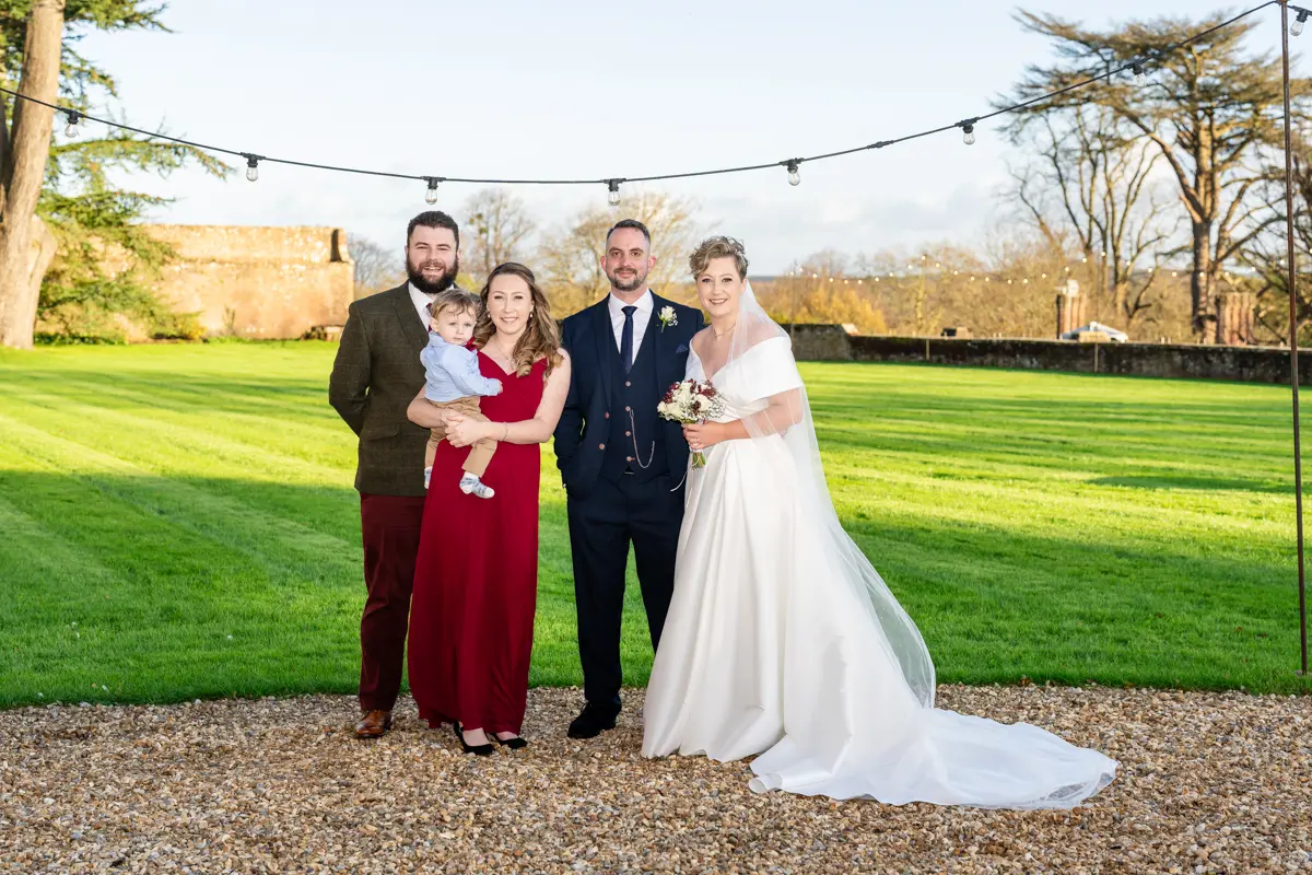 Group photo with bride and groom at Farnham Castle wedding.