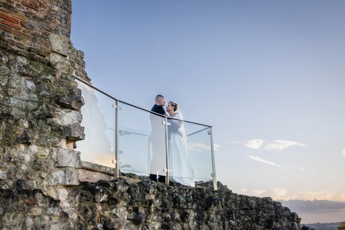 Bride and groom on viewing platform of castle keep at their Farnham Castle wedding.