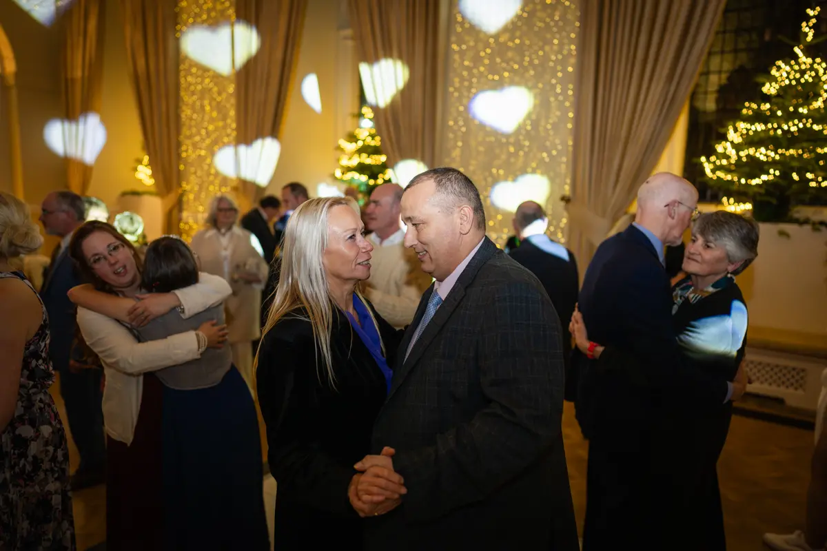 Guests dancing in the great hall at a Farnham Castle wedding.